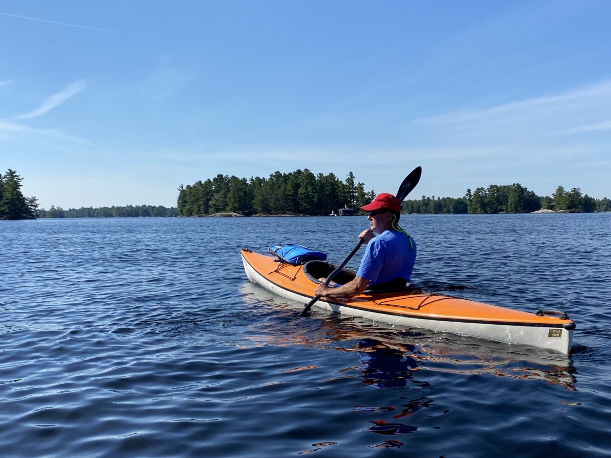 John Fincham paddling on Kahshe Lake